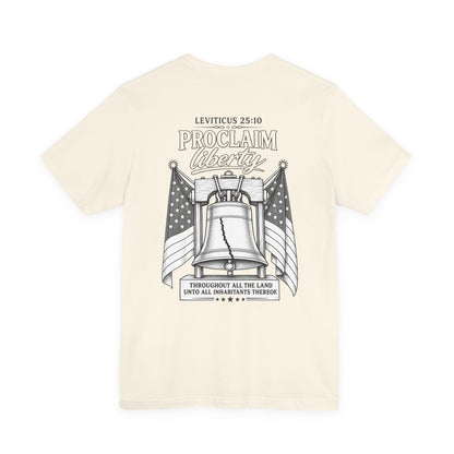 Proclaim Liberty Tee — Liberty Bell & Flags Bible Verse (Leviticus 25:10)